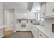 Bright kitchen with white cabinetry, appliances, and countertop, and a stainless steel sink at 208 Kentucky Dr, Ladson, SC 29456