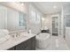 Modern bathroom featuring a soaking tub, marble floors, and updated vanity at 2123 Boatwright Rd, Johns Island, SC 29455