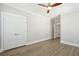 Bright bedroom features a ceiling fan, wood-look flooring, and double door closet at 2123 Boatwright Rd, Johns Island, SC 29455