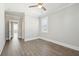 This bedroom has light gray walls, a ceiling fan, wood-look floors, and a window with blinds at 2123 Boatwright Rd, Johns Island, SC 29455