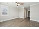 This bedroom has light gray walls, a ceiling fan, wood-look floors, and a window with blinds at 2123 Boatwright Rd, Johns Island, SC 29455
