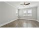 This bedroom has wood-look floors, a ceiling fan, base moulding, and two windows with blinds at 2123 Boatwright Rd, Johns Island, SC 29455