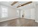 Bright bedroom features hardwood floors, natural light, and tray ceiling with wooden beams at 2123 Boatwright Rd, Johns Island, SC 29455