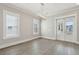 Dining room with hardwood floors, contemporary light fixture, and french doors to the outdoor porch at 2123 Boatwright Rd, Johns Island, SC 29455