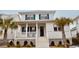 Charming two-story home featuring a welcoming front porch, white siding, and teal shutters at 2123 Boatwright Rd, Johns Island, SC 29455