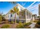 Exterior of a white house, showcasing a screened-in porch and a beautiful palm tree at 2123 Boatwright Rd, Johns Island, SC 29455