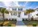 Charming two-story home with a front porch, landscaped yard, and palm trees at 2123 Boatwright Rd, Johns Island, SC 29455