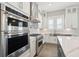 Bright kitchen with stainless steel KitchenAid appliances, shaker cabinets, and white subway tile backsplash at 2123 Boatwright Rd, Johns Island, SC 29455