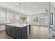 Bright kitchen with center island, hardwood floors, stainless appliances, and french doors to the outdoor porch at 2123 Boatwright Rd, Johns Island, SC 29455