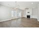 Living room with hardwood floors, custom built-ins, fireplace, and french doors to the outdoor porch at 2123 Boatwright Rd, Johns Island, SC 29455