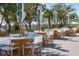 Charming outdoor dining space with wicker tables and white chairs, perfect for entertaining guests at 2123 Boatwright Rd, Johns Island, SC 29455