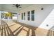 Covered porch with wood floors, ceiling fan, and white railing at 2123 Boatwright Rd, Johns Island, SC 29455