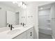 Modern bathroom featuring double sinks with sleek black faucets and a shower/tub combo at 2181 Blue Bayou Blvd, Johns Island, SC 29455