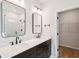 Bathroom showcasing a double vanity, quartz countertop, black hardware, and a glass-enclosed shower at 2181 Blue Bayou Blvd, Johns Island, SC 29455