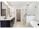 Modern bathroom featuring double vanity, soaking tub, and glass enclosed shower with white subway tiles at 2181 Blue Bayou Blvd, Johns Island, SC 29455