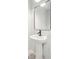 Stylish pedestal sink and mirror in a well-lit half bathroom, perfect for guests at 2181 Blue Bayou Blvd, Johns Island, SC 29455