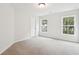 Bright, neutral bedroom with two windows providing natural light and a comfortable carpeted floor at 2181 Blue Bayou Blvd, Johns Island, SC 29455