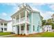 Side view of charming two-story home with a covered porch and balcony, featuring a light blue exterior and white trim at 2181 Blue Bayou Blvd, Johns Island, SC 29455