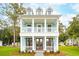 Charming two-story home with a covered porch and balcony, featuring a light blue exterior and white trim at 2181 Blue Bayou Blvd, Johns Island, SC 29455
