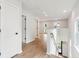 Bright hallway with wood floors leading to the living area and featuring a staircase at 2181 Blue Bayou Blvd, Johns Island, SC 29455
