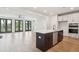 A kitchen island features a sink and dishwasher with stainless steel appliances nearby at 2181 Blue Bayou Blvd, Johns Island, SC 29455