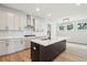 This modern kitchen features stainless steel appliances, white cabinets, and a large island at 2181 Blue Bayou Blvd, Johns Island, SC 29455