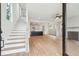 Open-concept living room with hardwood floors, a staircase, and a view into the kitchen at 2181 Blue Bayou Blvd, Johns Island, SC 29455