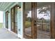 Close up view of the light streaming through the dark trimmed glass doors leading to a covered patio at 2181 Blue Bayou Blvd, Johns Island, SC 29455