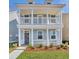 Charming two-story home with double covered porches, white columns, and manicured landscaping at 2205 Blue Bayou Blvd, Johns Island, SC 29455
