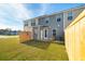Cozy backyard featuring a well-maintained lawn, patio seating, and a wooden privacy fence at 221 Abercom Place Dr, Moncks Corner, SC 29461