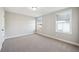 Bright bedroom with neutral carpet, two windows, and fresh paint at 221 Abercom Place Dr, Moncks Corner, SC 29461