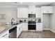 Modern kitchen with white cabinetry, stainless steel appliances, gray granite counters, and wood-look flooring at 221 Abercom Place Dr, Moncks Corner, SC 29461