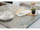 Close up on an island with granite counters, seating, and decor at 221 Abercom Place Dr, Moncks Corner, SC 29461
