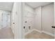 Well lit laundry room with tile flooring and an overhead wire rack shelf at 221 Abercom Place Dr, Moncks Corner, SC 29461