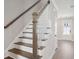 Staircase with white risers and stained wood treads and banister at 221 Abercom Place Dr, Moncks Corner, SC 29461