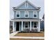 Charming two-story home with a covered front porch and manicured lawn at 2221 Blue Bayou Blvd, Johns Island, SC 29455