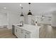 An open-concept kitchen and living area with a kitchen island and hardwood floors at 2221 Blue Bayou Blvd, Johns Island, SC 29455