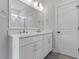 Double vanity bathroom with white cabinets, modern fixtures, and a large mirror at 2225 Blue Bayou Blvd, Johns Island, SC 29455
