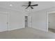 A simple bedroom with neutral carpet, ceiling fan, and view to the upper hallway at 2225 Blue Bayou Blvd, Johns Island, SC 29455