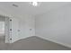 A bright bedroom enhanced by double door closets, neutral carpet, and view to the hall at 2225 Blue Bayou Blvd, Johns Island, SC 29455