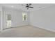 A serene bedroom features a ceiling fan and access to an outdoor balcony offering a bright living space at 2225 Blue Bayou Blvd, Johns Island, SC 29455