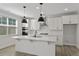Stylish kitchen featuring white cabinets, marble countertops, and stainless appliances at 2225 Blue Bayou Blvd, Johns Island, SC 29455