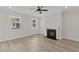 Sunlit living area featuring a fireplace and two windows with natural light at 2225 Blue Bayou Blvd, Johns Island, SC 29455