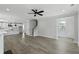Open concept living room with wood floors flows into a kitchen and staircase at 2225 Blue Bayou Blvd, Johns Island, SC 29455