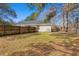 Fenced backyard providing privacy, with green grass, trees, and a view of the home's exterior at 228 Two Pond Loop, Ladson, SC 29456
