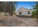Backyard featuring mature trees, a sliding glass door to patio, and a privacy fence at 228 Two Pond Loop, Ladson, SC 29456