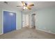 Bedroom with carpet, ceiling fan, blue closet, and doorways to other rooms at 228 Two Pond Loop, Ladson, SC 29456