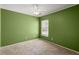 A green bedroom features carpet, neutral trim, and a window with blinds at 228 Two Pond Loop, Ladson, SC 29456
