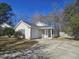 Charming single-story home with neutral siding, attached garage, and well-maintained landscaping on a sunny day at 228 Two Pond Loop, Ladson, SC 29456