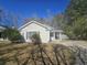 Well-kept single-story home with a manicured lawn and mature trees providing shade and curb appeal at 228 Two Pond Loop, Ladson, SC 29456